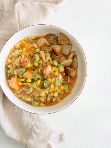 a bowl of succotash with roasted potatoes