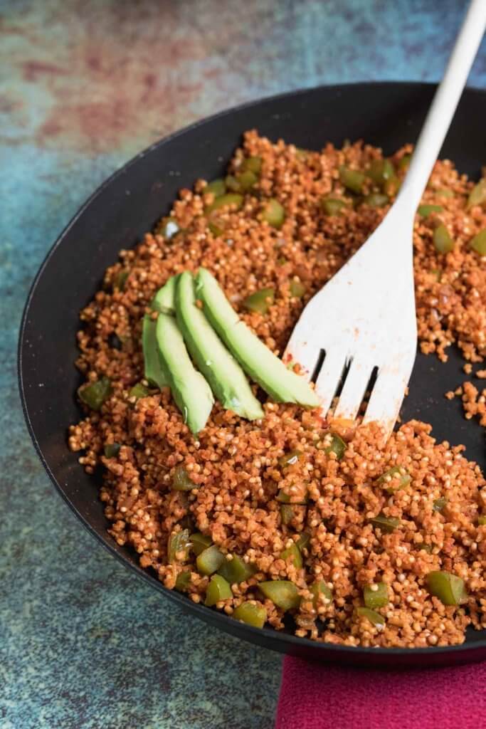 spanish millet in a skillet with avocado
