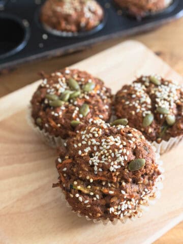 a stack of 3 vegan morning glory muffins made with sprouted spelt flour